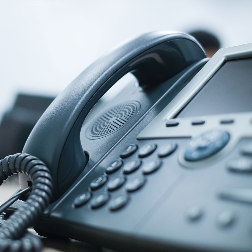 The image shows a modern office space with a sleek desk, chair, and computer setup, featuring wood paneling, a white countertop, and a contemporary design.